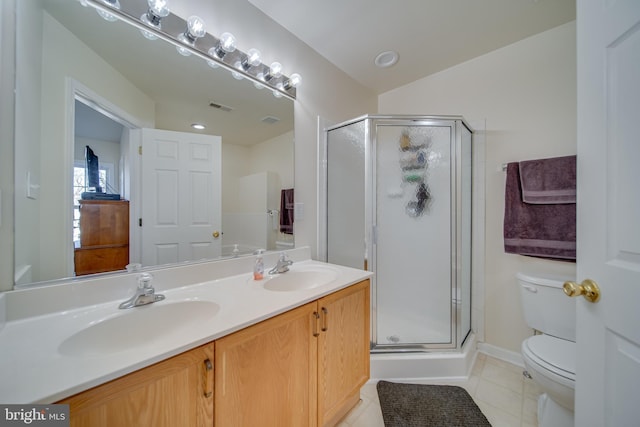 bathroom featuring walk in shower, vanity, tile patterned floors, and toilet