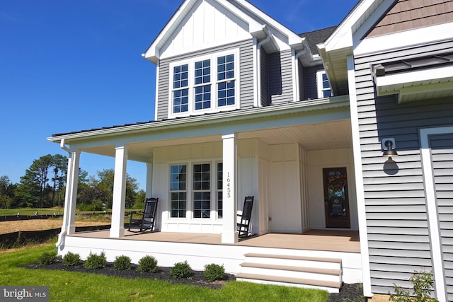 view of exterior entry with a porch