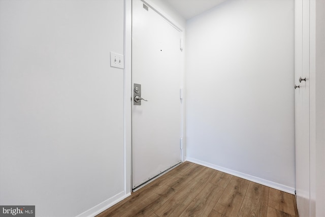 interior space with baseboards and wood finished floors