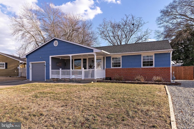 single story home with a garage, a front yard, and covered porch