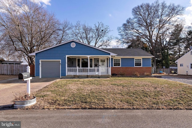 ranch-style home featuring a garage, a front yard, and covered porch