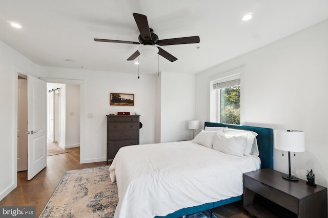 bedroom featuring hardwood / wood-style flooring and ceiling fan