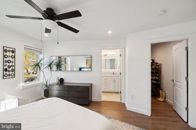 bedroom featuring dark wood-type flooring, ceiling fan, and ensuite bathroom