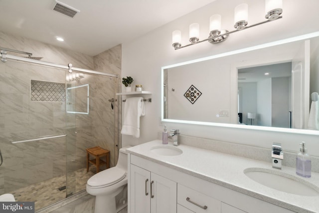 bathroom featuring walk in shower, vanity, and toilet