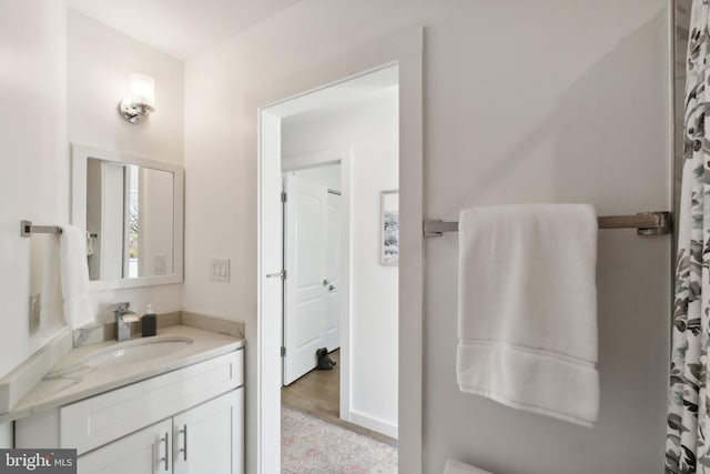 bathroom with vanity and hardwood / wood-style floors