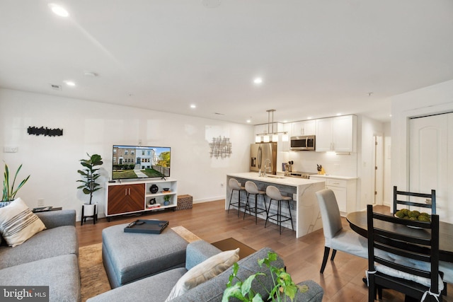 living room with sink and hardwood / wood-style floors