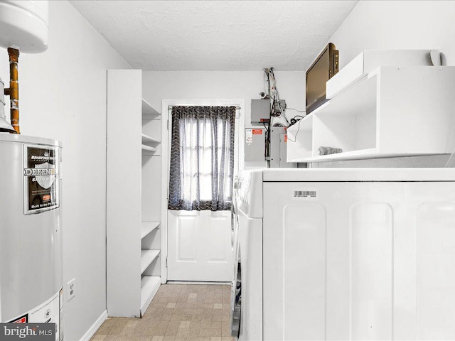 washroom featuring washer / clothes dryer, water heater, and a textured ceiling