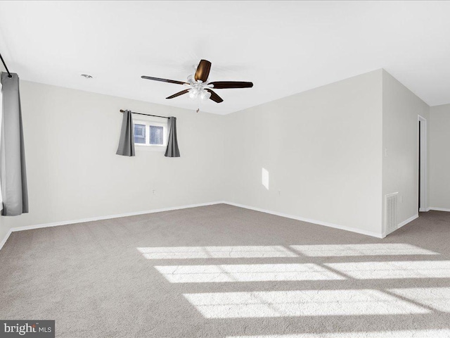 carpeted spare room with ceiling fan