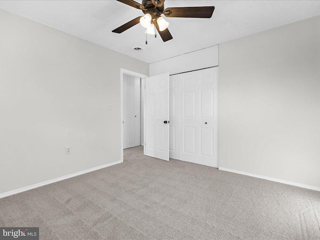 unfurnished bedroom with light colored carpet, a closet, and ceiling fan