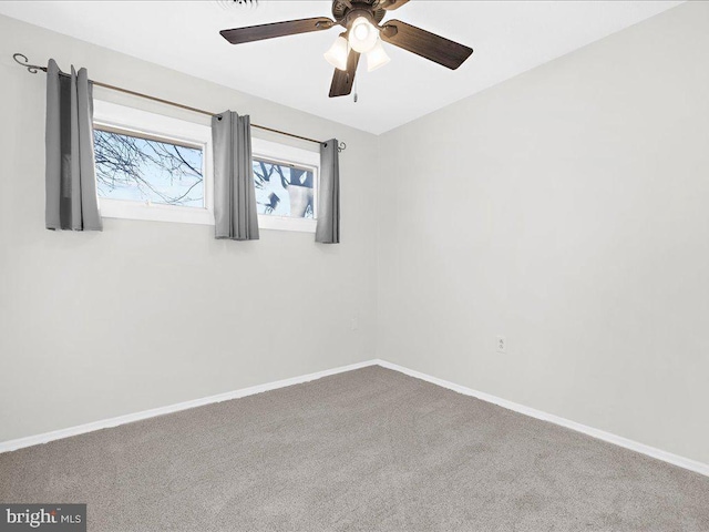 carpeted spare room with ceiling fan