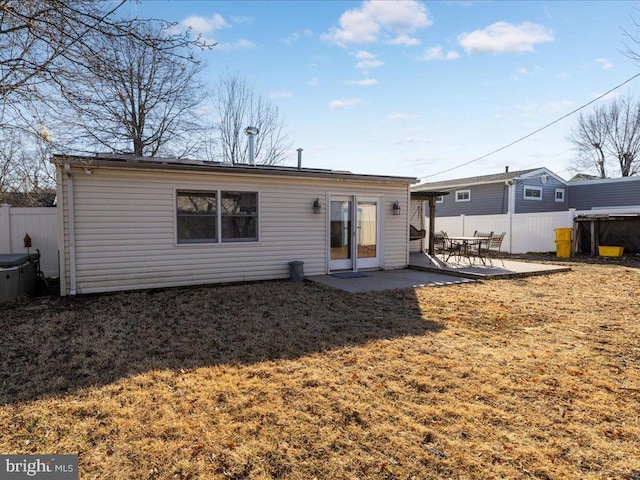 back of property featuring a lawn and a patio