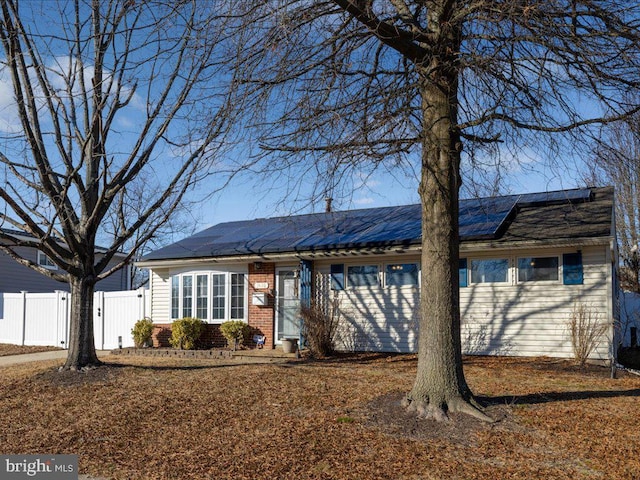 ranch-style home with solar panels