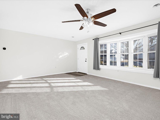 carpeted spare room with ceiling fan