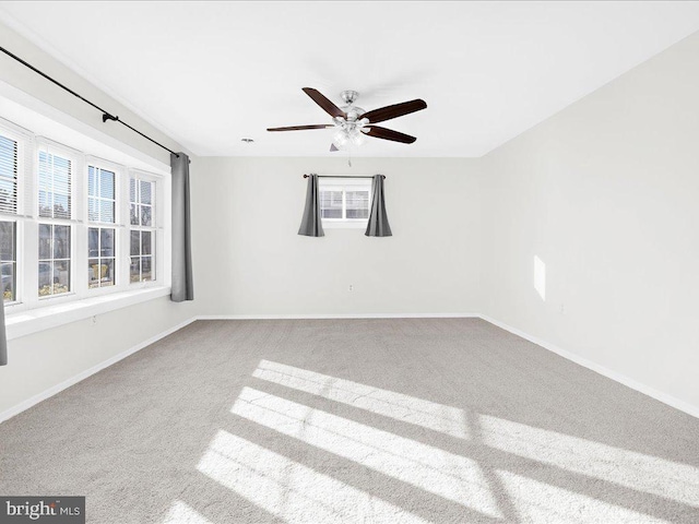 spare room featuring carpet floors and ceiling fan