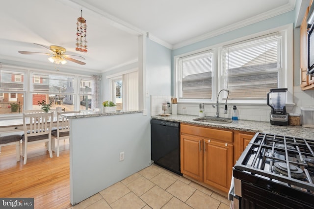 kitchen with sink, dishwasher, stainless steel gas stove, light stone counters, and ornamental molding