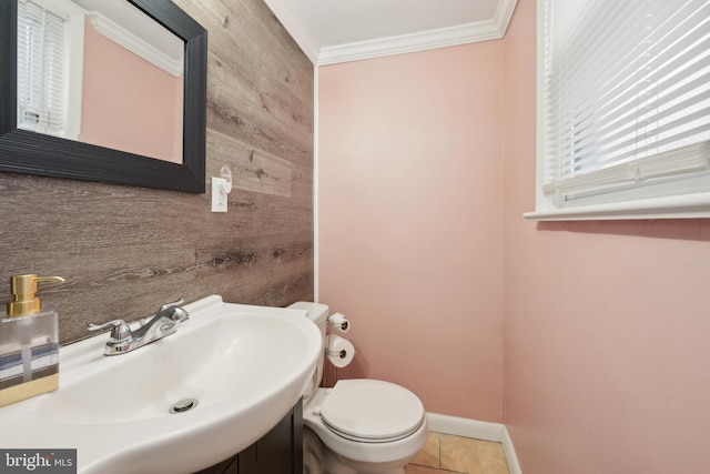 bathroom featuring wood walls, sink, tile patterned flooring, ornamental molding, and toilet