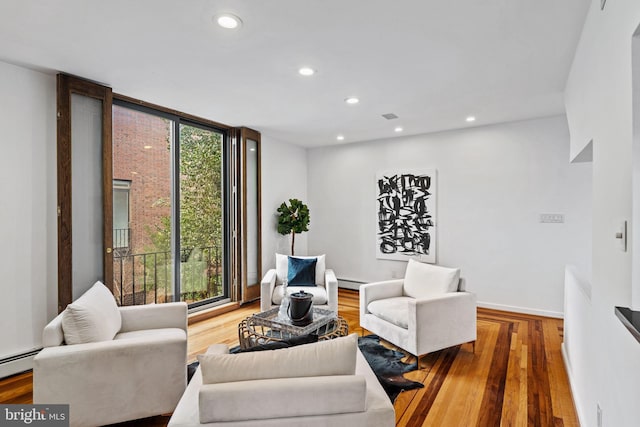 living room featuring hardwood / wood-style flooring, plenty of natural light, and expansive windows