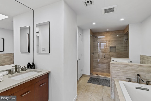 bathroom featuring vanity, separate shower and tub, and tile patterned floors