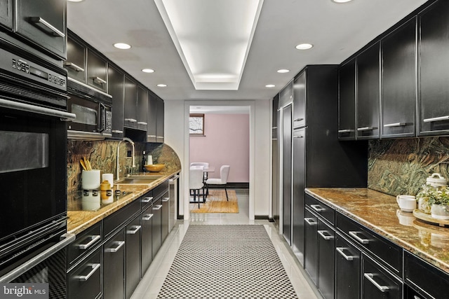 kitchen featuring sink, backsplash, light tile patterned floors, light stone counters, and black appliances