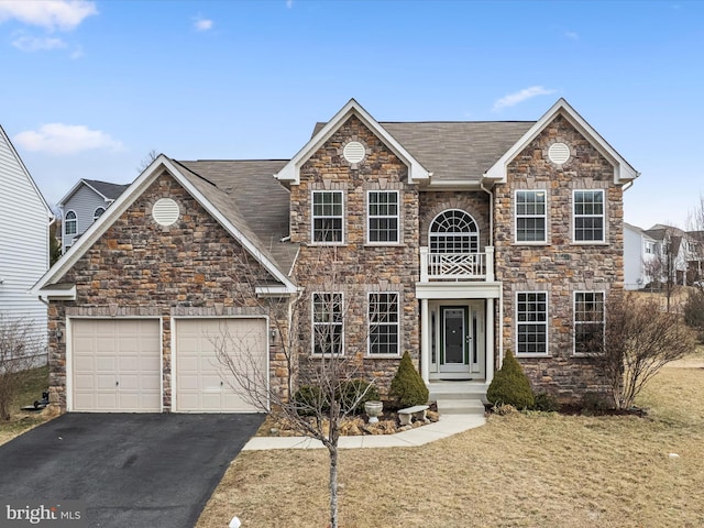 view of front of home with a garage, aphalt driveway, and roof with shingles