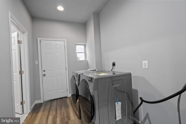 laundry room with separate washer and dryer and hardwood / wood-style floors