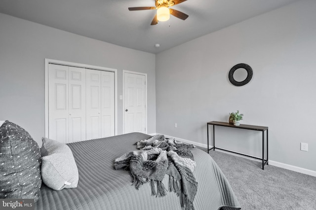 carpeted bedroom with ceiling fan and a closet