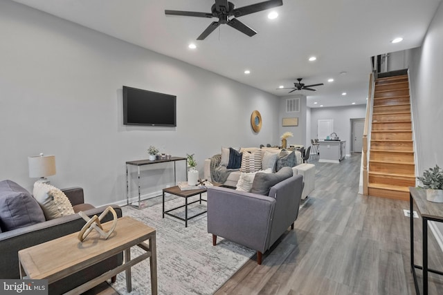 living room with hardwood / wood-style flooring and ceiling fan