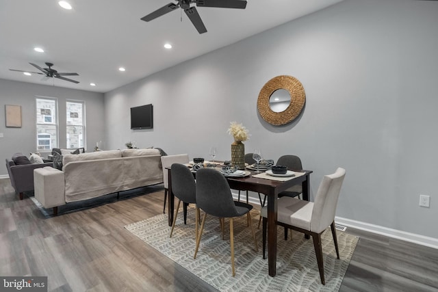 dining area featuring wood-type flooring and ceiling fan