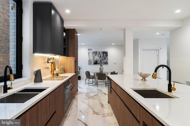 kitchen featuring wall oven, sink, and black electric stovetop