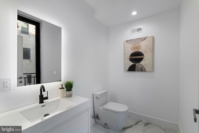 bathroom with vanity and toilet