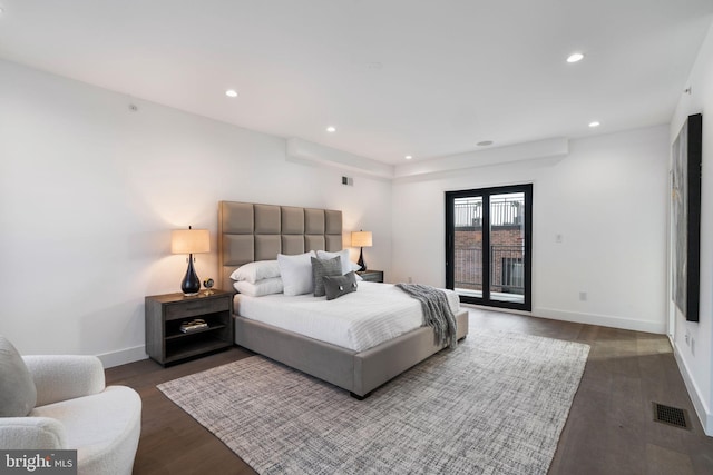 bedroom featuring dark hardwood / wood-style floors and access to outside