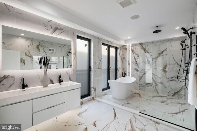 bathroom featuring vanity and shower with separate bathtub