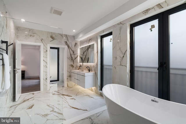 bathroom with a bathing tub and vanity