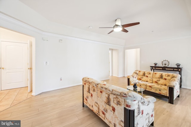 living room with crown molding, ceiling fan, and light hardwood / wood-style flooring