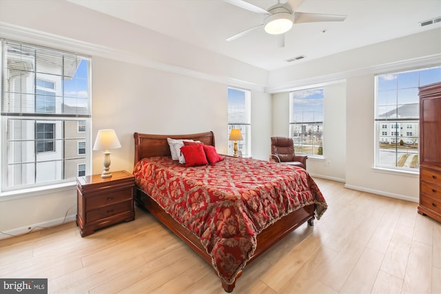 bedroom with light hardwood / wood-style floors and ceiling fan