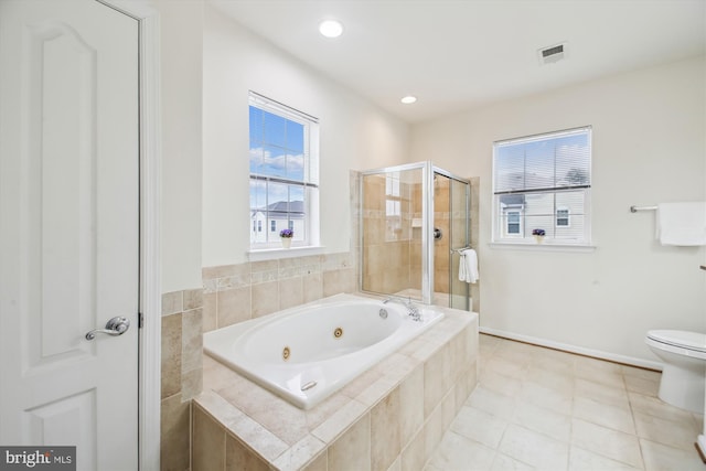 bathroom featuring independent shower and bath, tile patterned flooring, and toilet