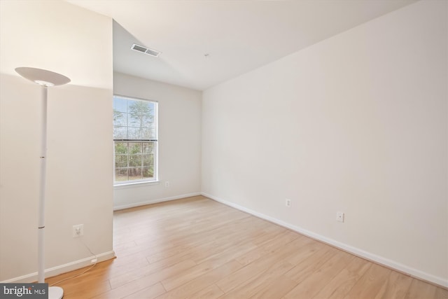 spare room featuring light hardwood / wood-style flooring