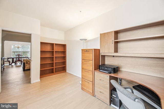 office with a chandelier and light hardwood / wood-style flooring