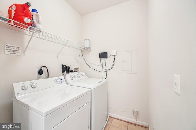 washroom with washing machine and dryer and light tile patterned floors