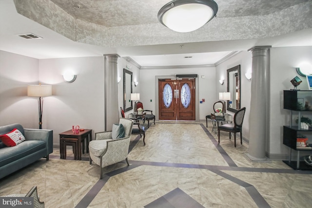 foyer with crown molding and decorative columns