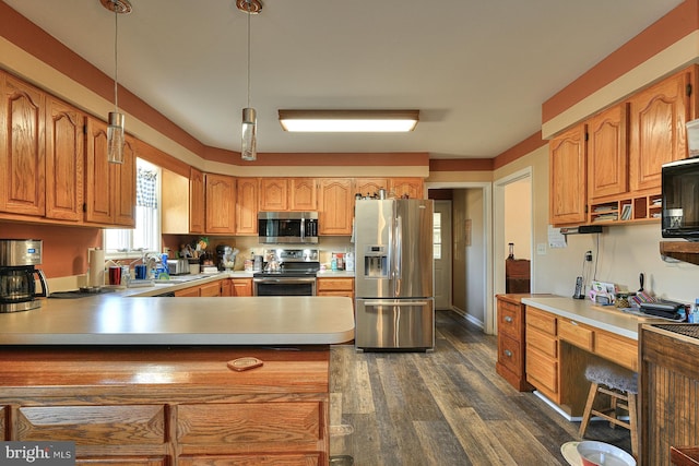 kitchen featuring pendant lighting, dark hardwood / wood-style flooring, stainless steel appliances, and kitchen peninsula