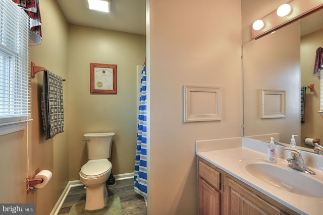 bathroom with vanity, wood-type flooring, and toilet