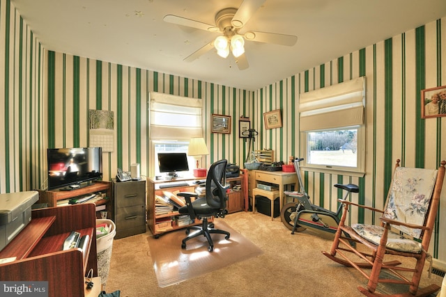 carpeted home office featuring ceiling fan