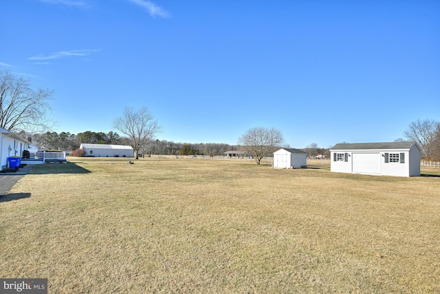 view of yard with a shed and a rural view