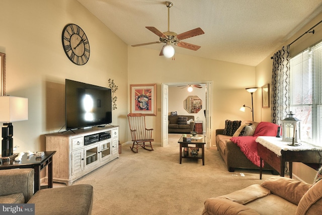 living room with ceiling fan, light colored carpet, and high vaulted ceiling