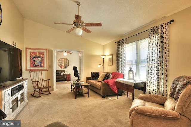 living room featuring lofted ceiling, a textured ceiling, light carpet, and ceiling fan