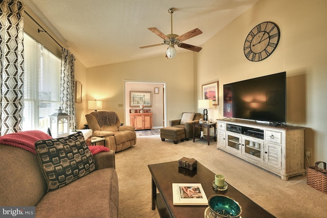 living room featuring lofted ceiling, a textured ceiling, light colored carpet, and ceiling fan