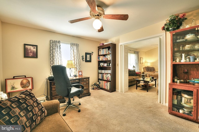 home office with light carpet and ceiling fan