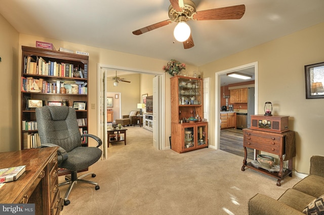 carpeted home office with ceiling fan