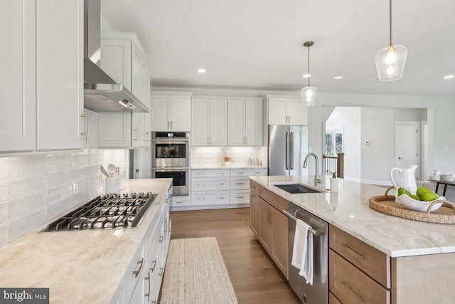 kitchen with light stone counters, appliances with stainless steel finishes, a large island, and white cabinets